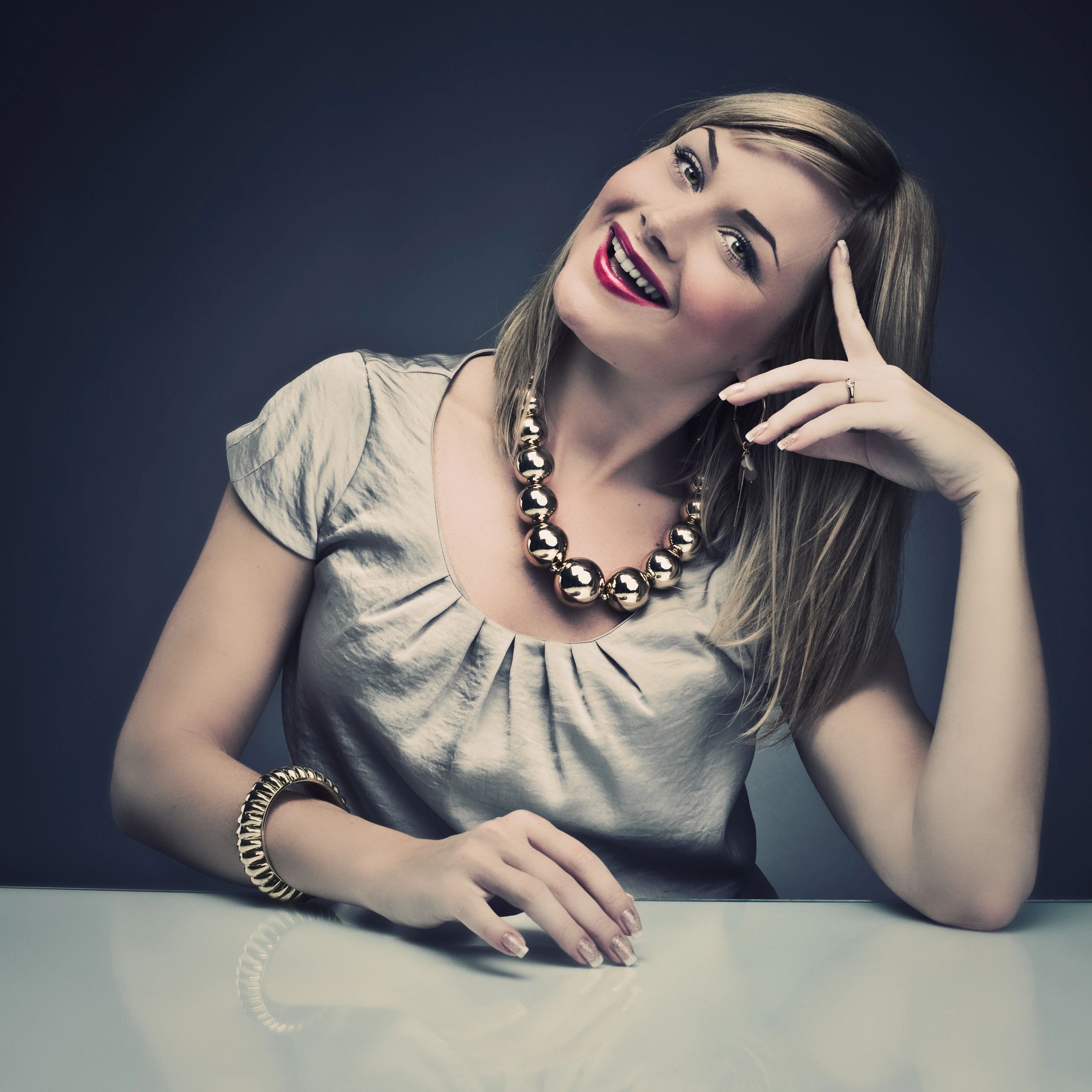 Client portrait: luxury buyer smiling in neutral setting