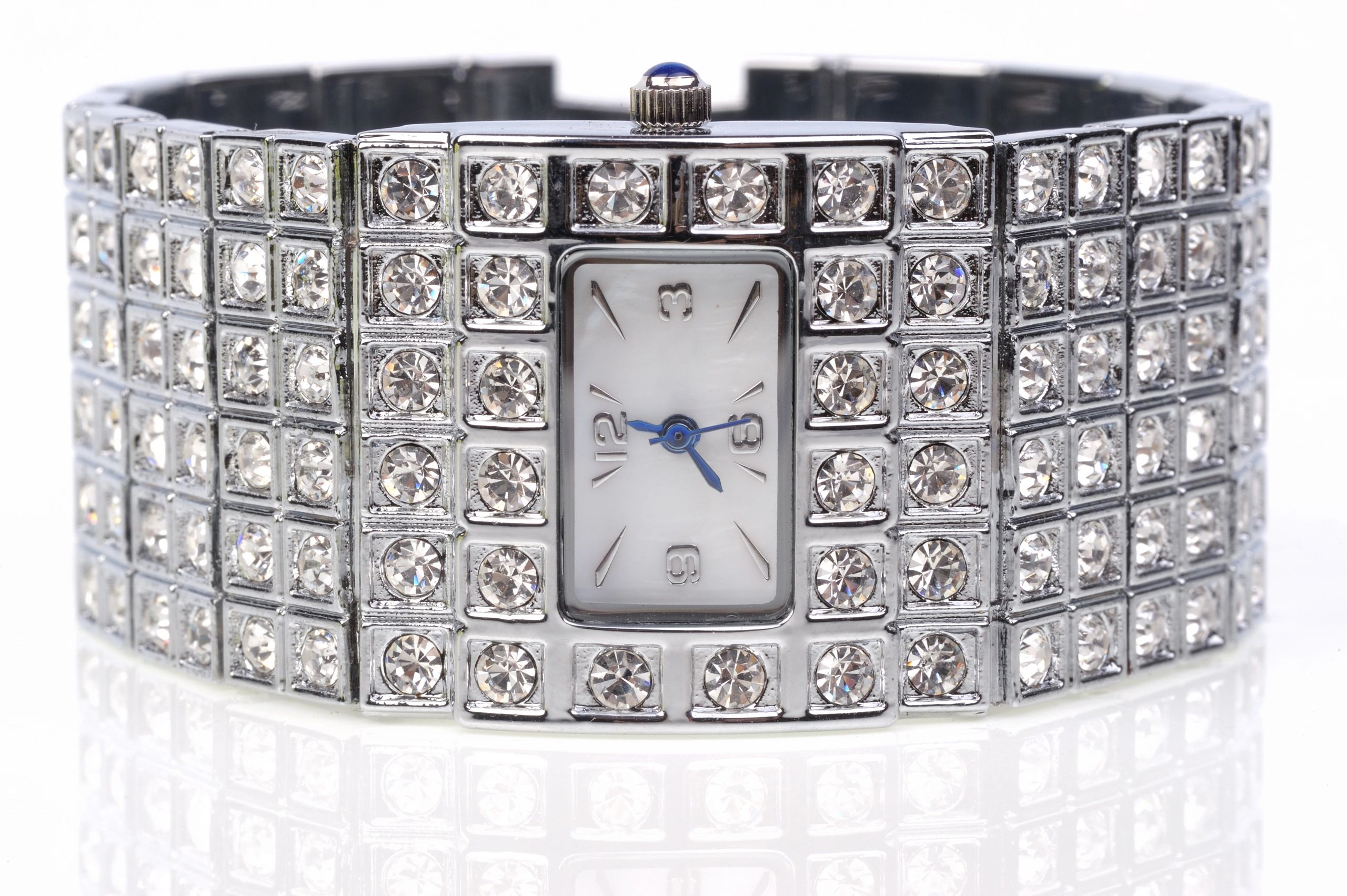 Diamond-set luxury watch close-up on ivory surface
