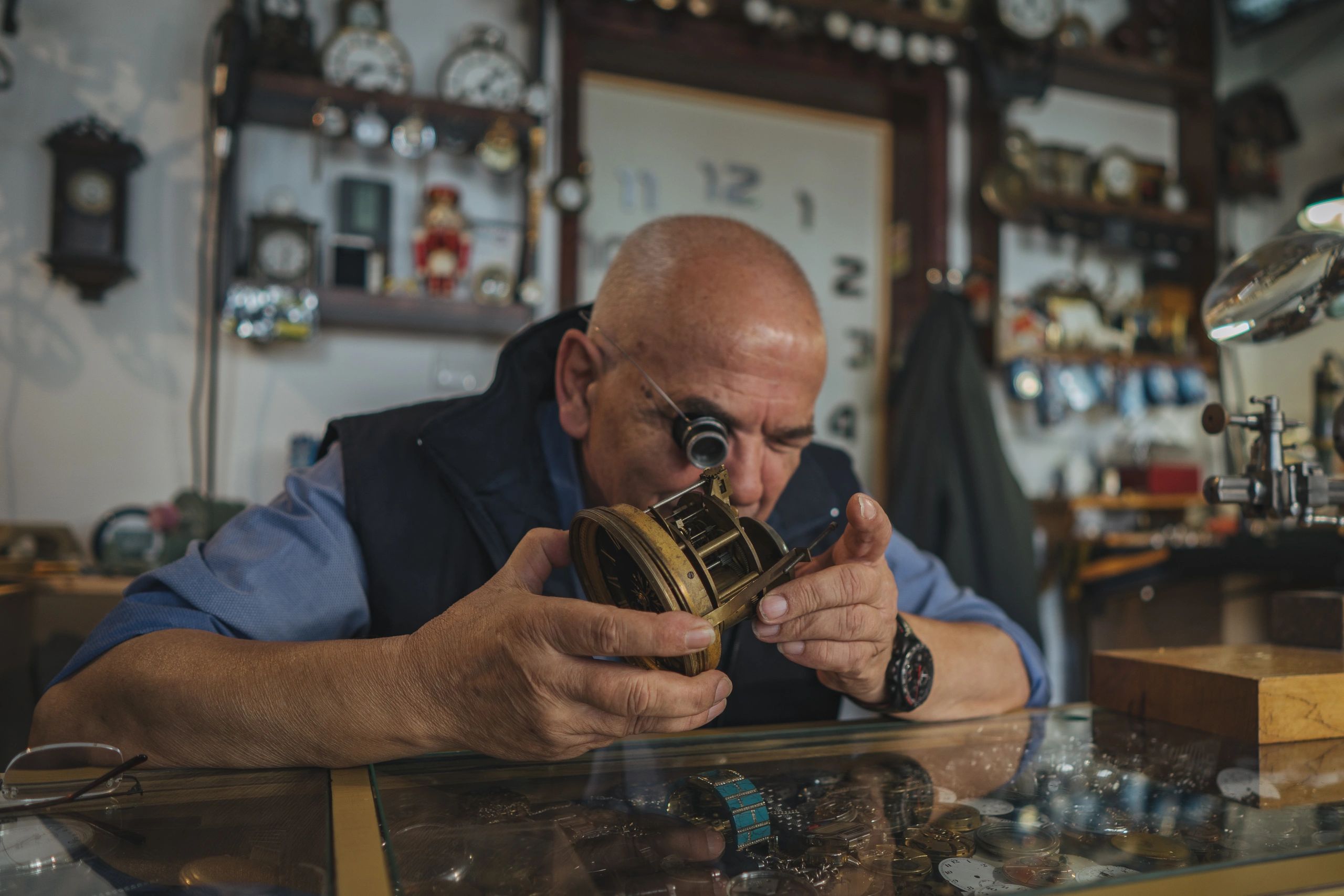 Watchmaker inspecting a timepiece in a workshop