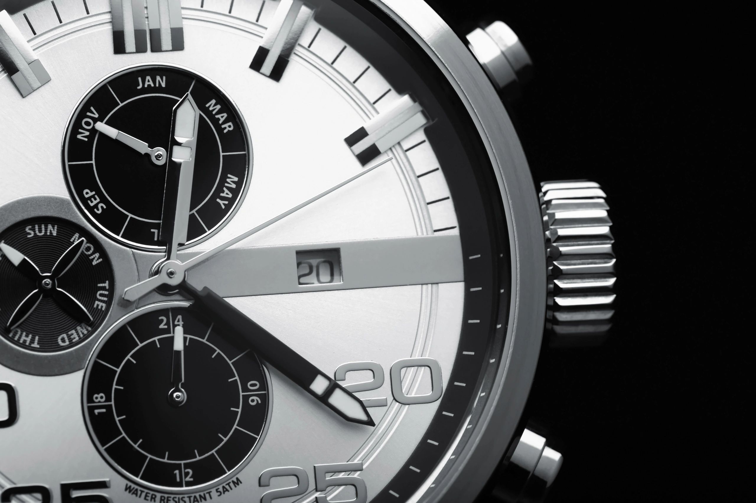 Black luxury wristwatch close-up on dark background