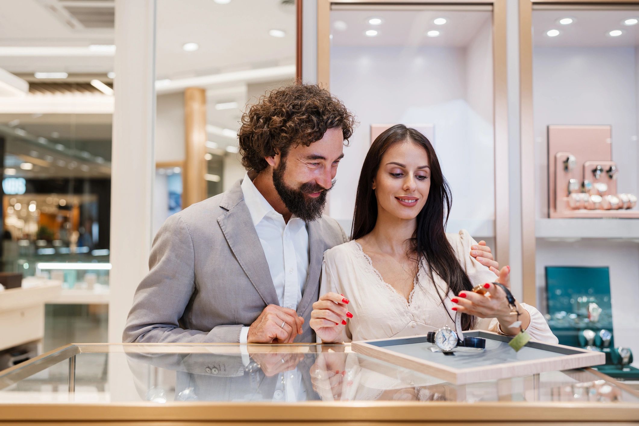 Couple examining a luxury wristwatch at a boutique counter