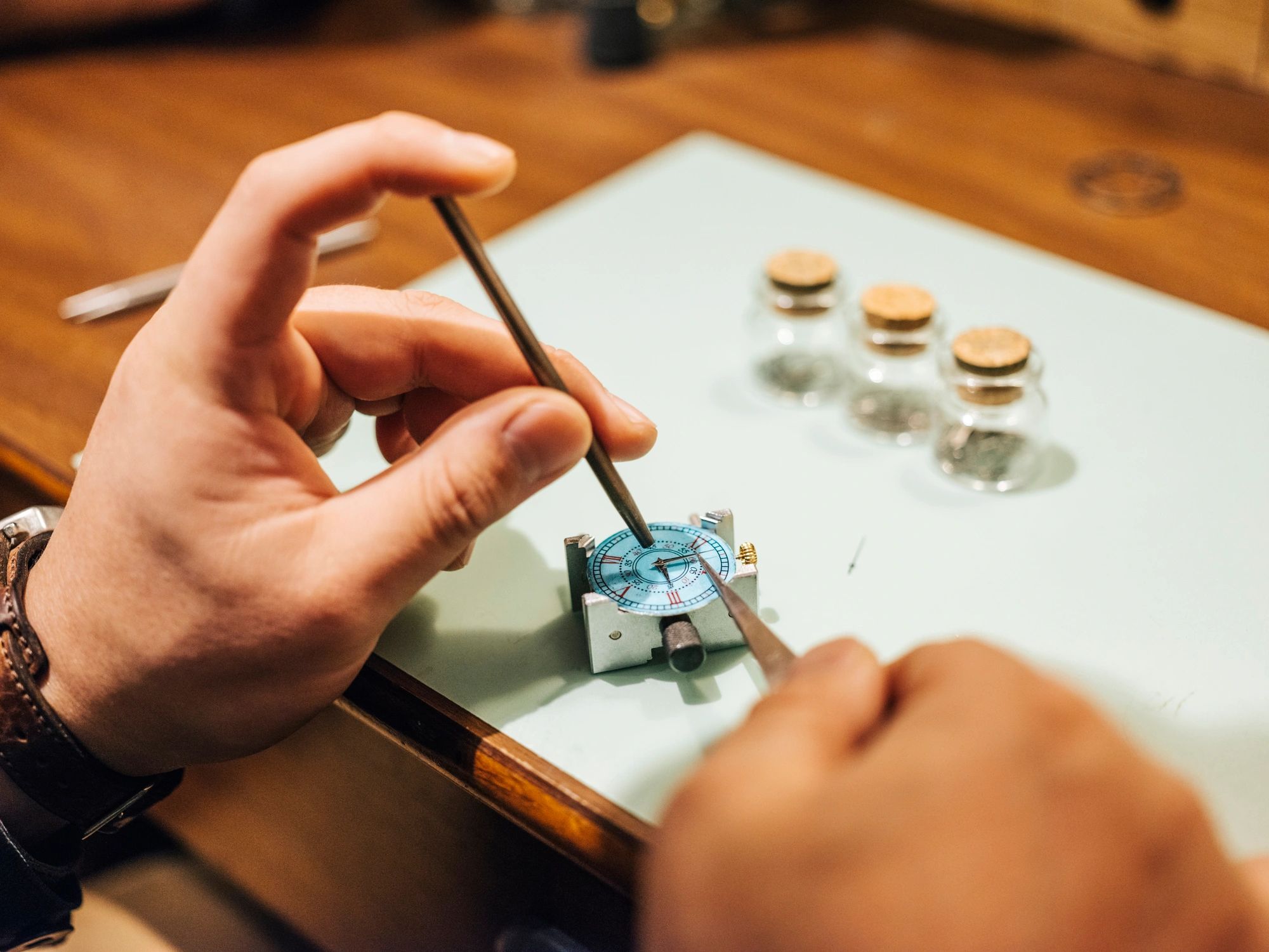 Watchmaker working at a bench in a workshop